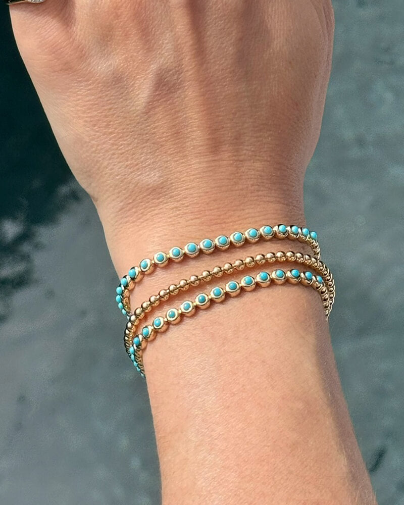 EF Collection 14k yellow gold bracelets with turquoise styled on wrist of model