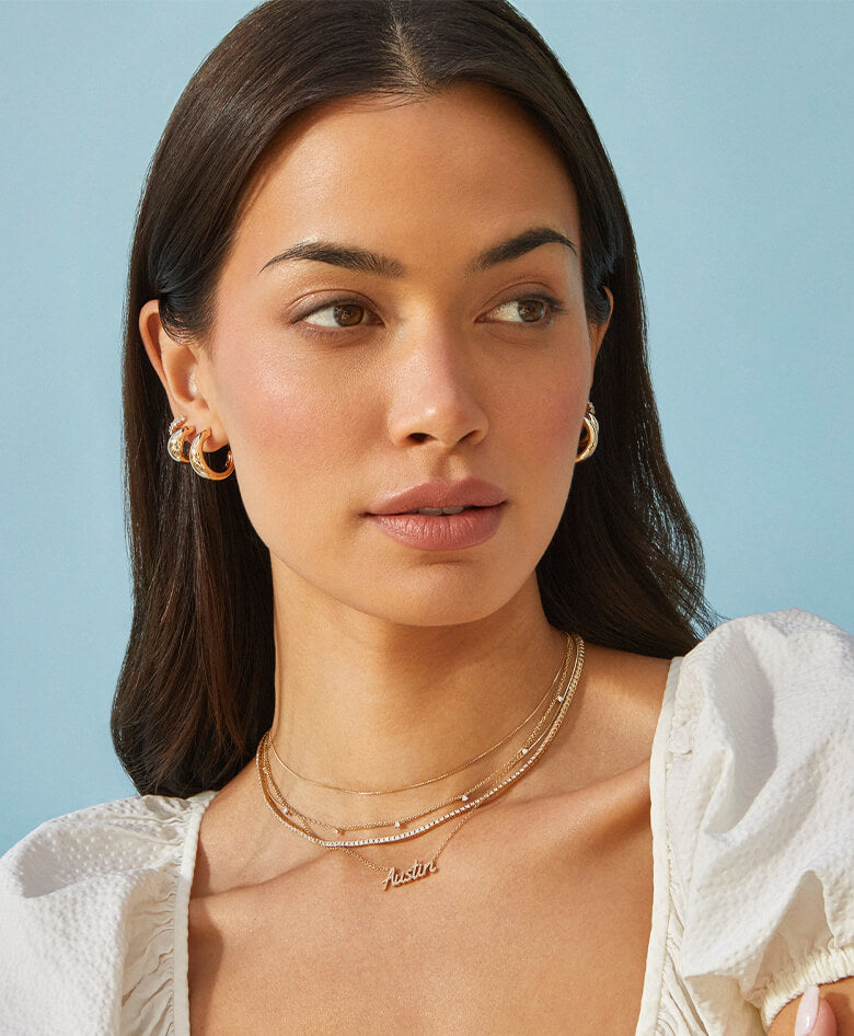 EF Collection 14k yellow gold earrings, necklaces, bracelets, and rings styled on model