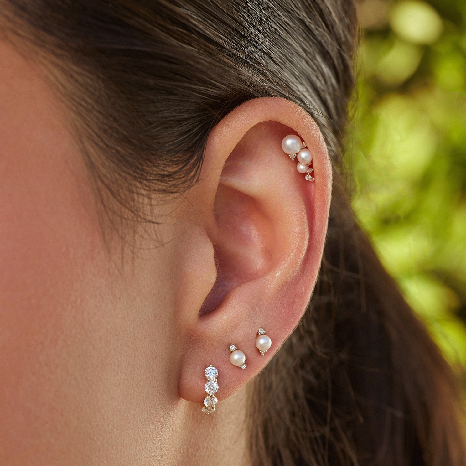 Diamond & Pearl Stud Earring styled on second and third earring hole of model with pearl and diamond earrings